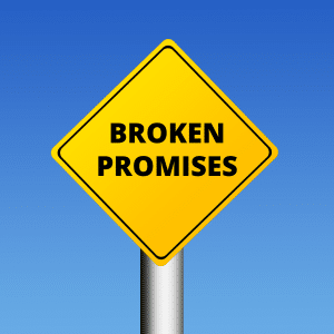 Yellow Road sign reads BROKEN PROMISES