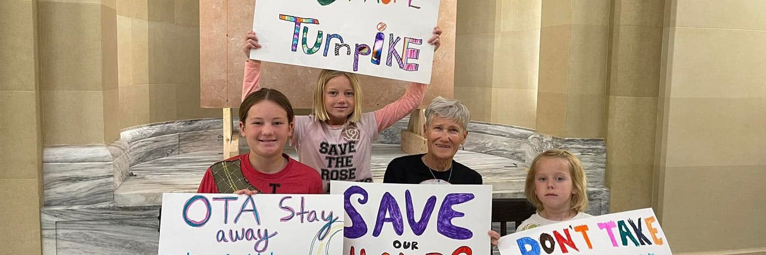 Rally at the Capitol - Family Holding Signs About the Oklahoma Turnpike Authority's Plans